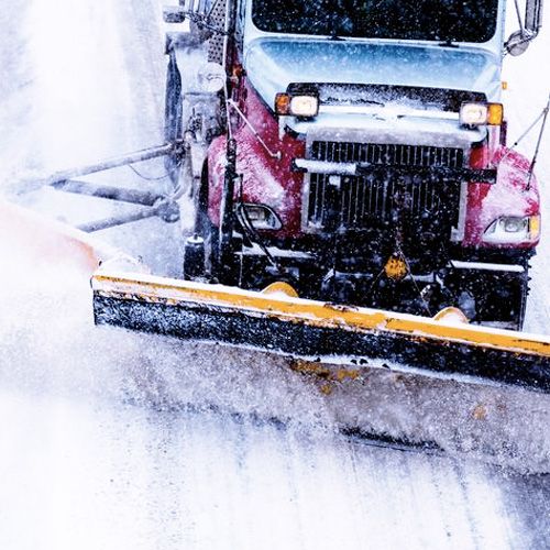 A commercial parking area cleared of snow by Black Swan Landscaping’s professional snow contractor services, ensuring a safe and accessible environment.