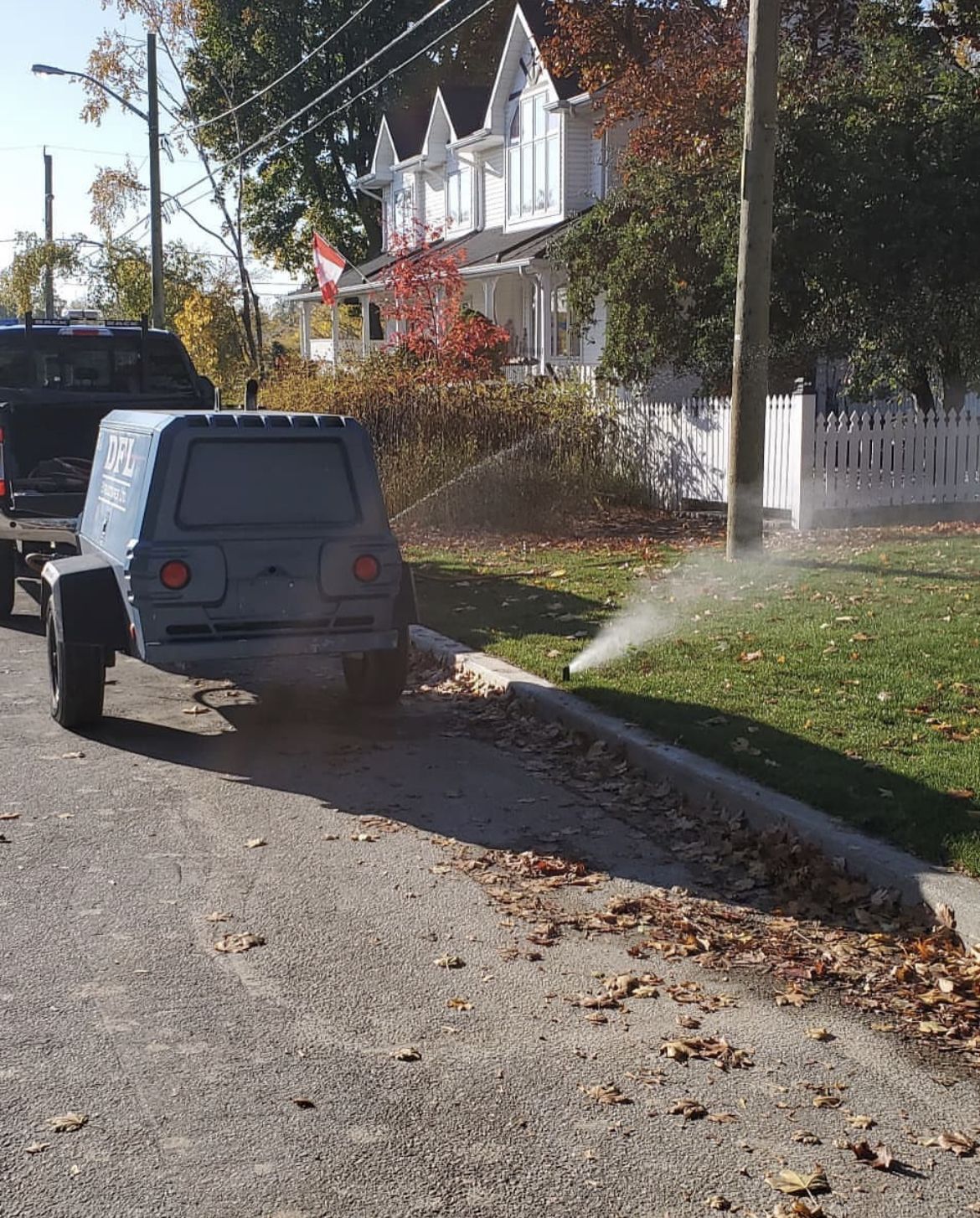 Image shows a work truck starting to bleed the lines for a sprinkler winterization