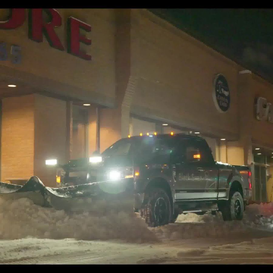 A commercial parking area cleared of snow by Black Swan Landscaping’s professional snow contractor services, ensuring a safe and accessible environment.