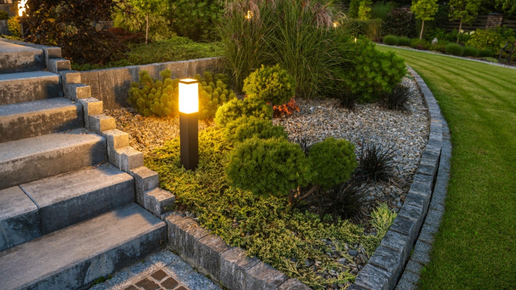 A light fixture illuminating a walkway and garden